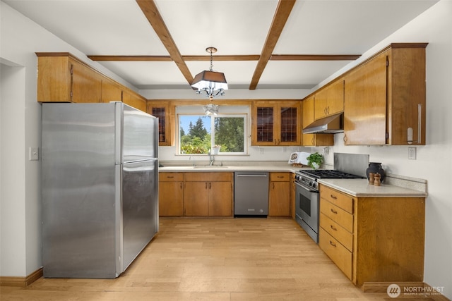 13016 8th Pl SW, Burien, WA 98146 - kitchen featuring stainless steel appliances, under cabinet range hood, light wood finished floors, light countertops, and beamed ceiling