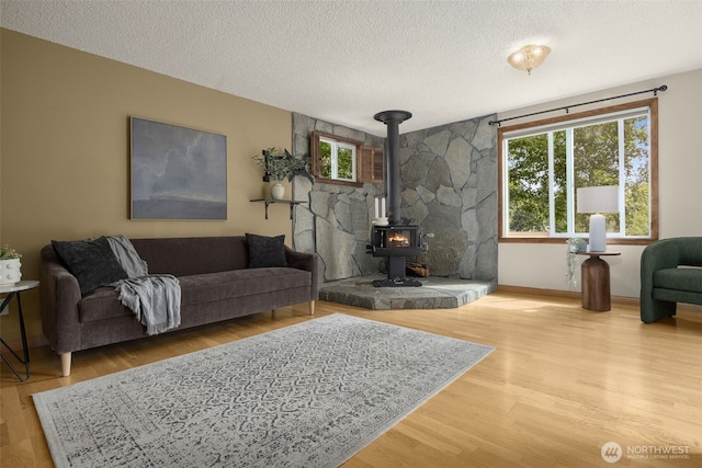 13016 8th Pl SW, Burien, WA 98146 - living area featuring a wood stove, a textured ceiling, and wood finished floors