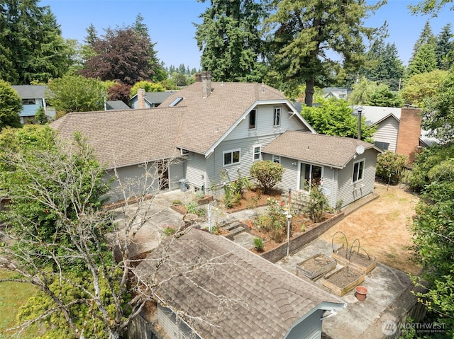 13016 8th Pl SW, Burien, WA 98146 - view of front of property featuring a garden, a shingled roof, concrete driveway, and a chimney