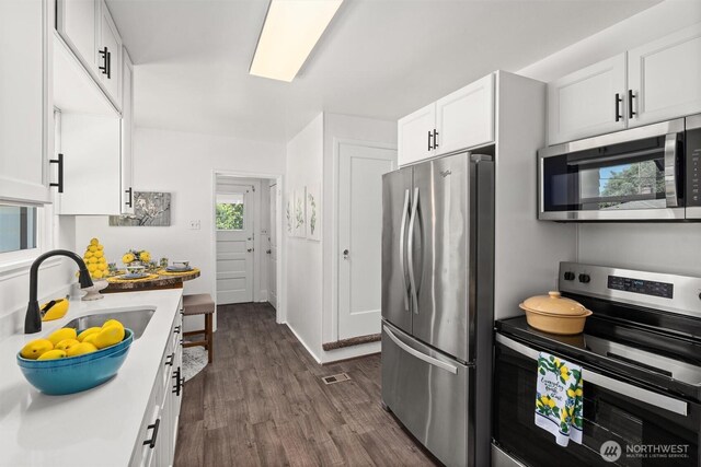 29260 Military Rd S, Federal Way, WA 98003 - kitchen with appliances with stainless steel finishes, dark wood-style floors, and white cabinetry