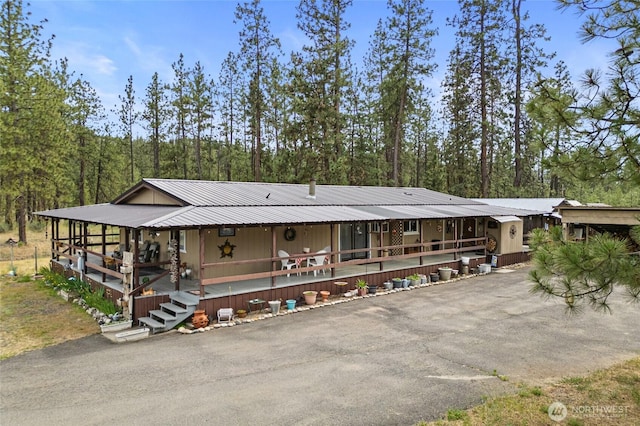 45019 Cougi Dr N, Davenport, WA 99122 - view of front of property with asphalt driveway, a metal roof, and covered porch