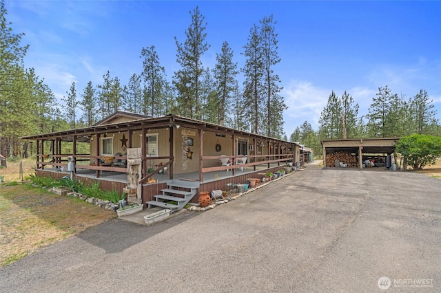 45019 Cougi Dr N, Davenport, WA 99122 - view of front facade with a detached carport, asphalt driveway, and a porch