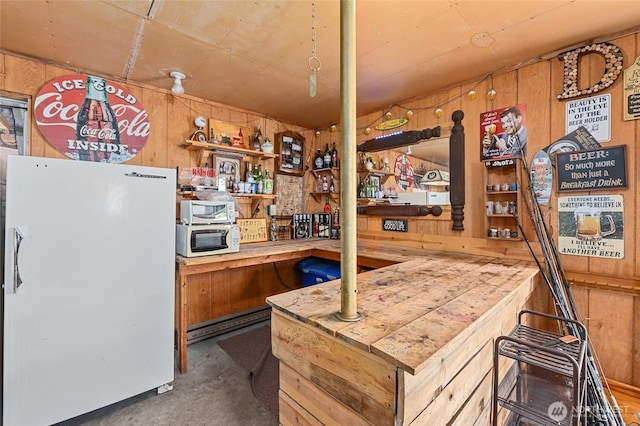 45019 Cougi Dr N, Davenport, WA 99122 - kitchen with white appliances, wooden walls, concrete floors, open shelves, and wood counters