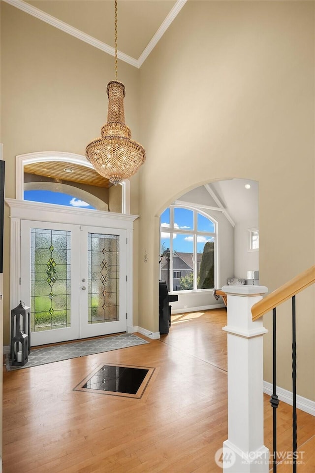 13804 SE 76th Pl, Newcastle, WA 98059 - foyer with wood finished floors, crown molding, a high ceiling, french doors, and a chandelier