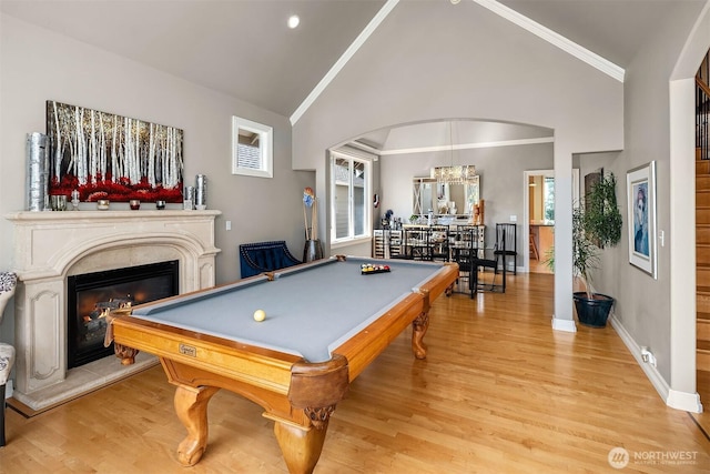 13804 SE 76th Pl, Newcastle, WA 98059 - rec room with lofted ceiling, billiards table, arched walkways, light wood finished floors, and a glass covered fireplace