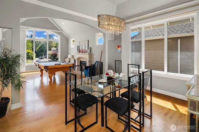 13804 SE 76th Pl, Newcastle, WA 98059 - dining room featuring arched walkways, light wood-style floors, vaulted ceiling, pool table, and a chandelier