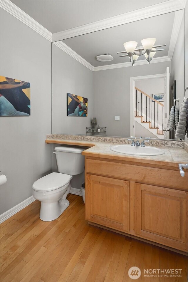 13804 SE 76th Pl, Newcastle, WA 98059 - half bath featuring vanity, ornamental molding, and hardwood / wood-style floors
