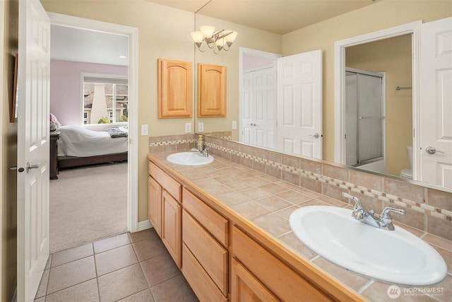 13804 SE 76th Pl, Newcastle, WA 98059 - ensuite bathroom with double vanity, an enclosed shower, tile patterned floors, and decorative backsplash