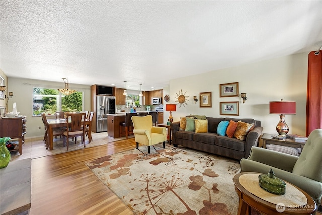 1227 137th St E, Tacoma, WA 98445 - living room with light wood-type flooring and a textured ceiling