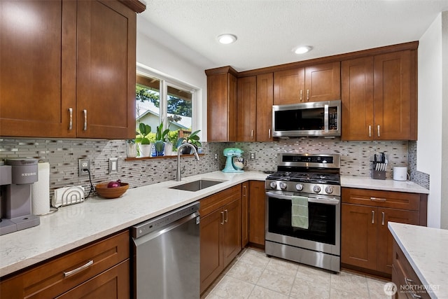 1227 137th St E, Tacoma, WA 98445 - kitchen featuring appliances with stainless steel finishes, light stone countertops, tasteful backsplash, and recessed lighting