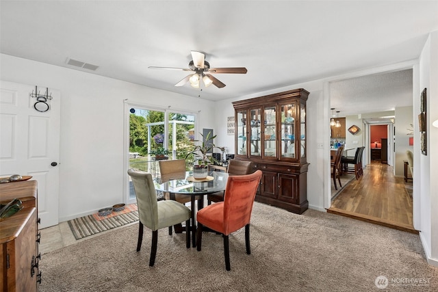 1227 137th St E, Tacoma, WA 98445 - dining area featuring ceiling fan and carpet flooring
