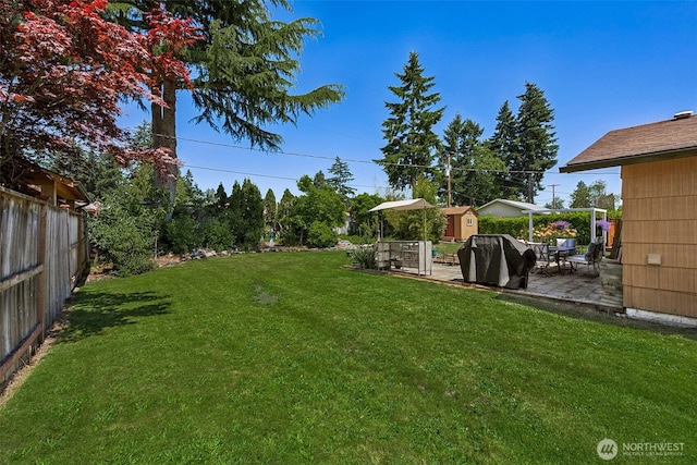 1227 137th St E, Tacoma, WA 98445 - fenced backyard featuring a patio and a storage unit