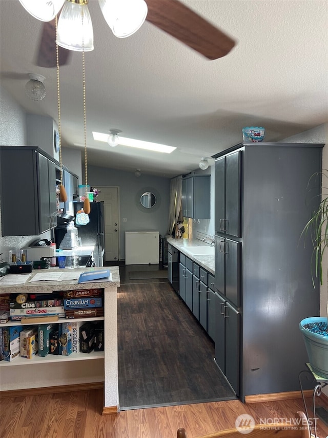 29306 O St, Ocean Park, WA 98640 - kitchen with freestanding refrigerator, light countertops, dark wood finished floors, dishwashing machine, and gray cabinets