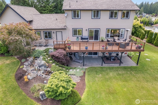 23017 138th Ave E, Graham, WA 98338 - back of house featuring a patio, a wooden deck, a yard, and roof with shingles