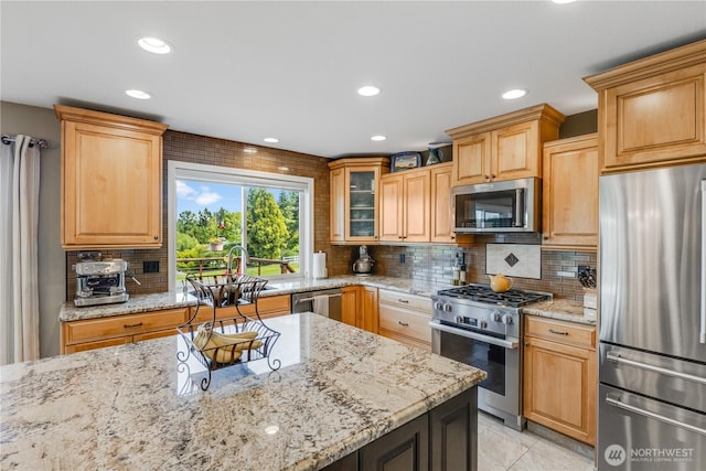 23017 138th Ave E, Graham, WA 98338 - kitchen with stainless steel appliances, backsplash, light stone counters, recessed lighting, and glass insert cabinets