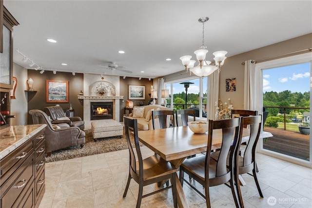 23017 138th Ave E, Graham, WA 98338 - dining room with ceiling fan, recessed lighting, a large fireplace, and a chandelier