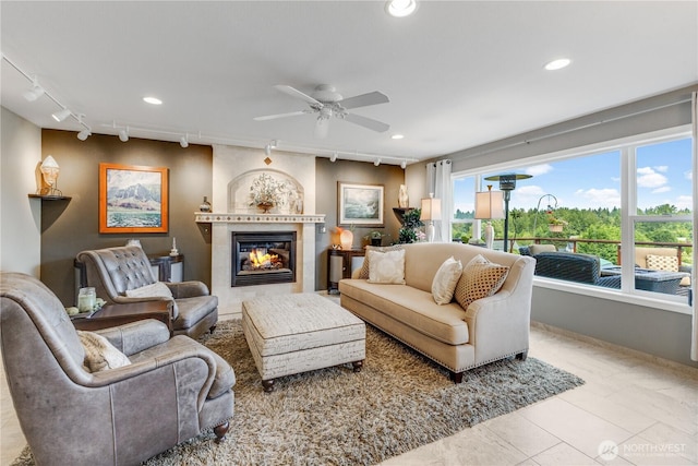 23017 138th Ave E, Graham, WA 98338 - tiled living area featuring a ceiling fan, a tile fireplace, recessed lighting, and track lighting