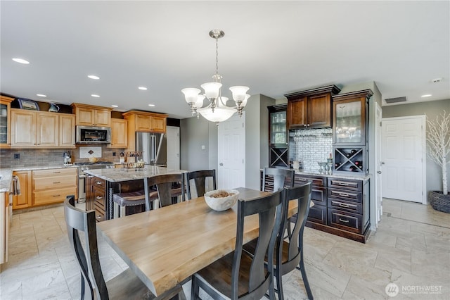 23017 138th Ave E, Graham, WA 98338 - dining space featuring a chandelier, recessed lighting, and light marble finish flooring