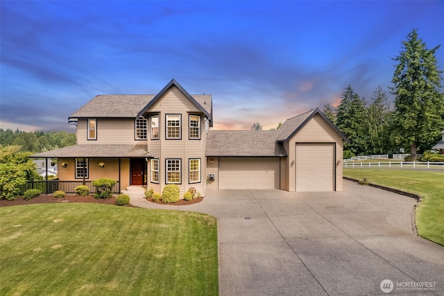 23017 138th Ave E, Graham, WA 98338 - traditional-style home featuring an attached garage, concrete driveway, covered porch, and a shingled roof