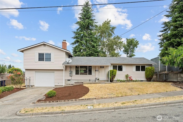 5257 N Dahl Dr, Tacoma, WA 98406 - view of front facade featuring a garage, concrete driveway, and a chimney