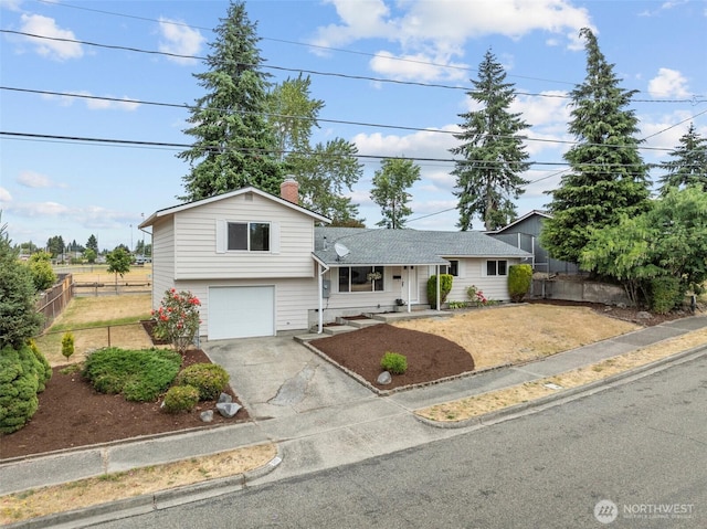 5257 N Dahl Dr, Tacoma, WA 98406 - view of front of home with a garage, asphalt driveway, and a chimney
