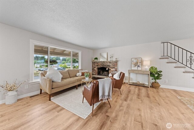 5257 N Dahl Dr, Tacoma, WA 98406 - living room featuring wood finished floors, stairway, a brick fireplace, and a textured ceiling