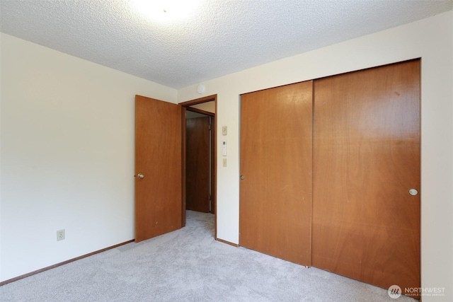 1264 SW Lanyard Loop Unit 2, Oak Harbor, WA 98277 - unfurnished bedroom featuring carpet floors, a closet, and a textured ceiling