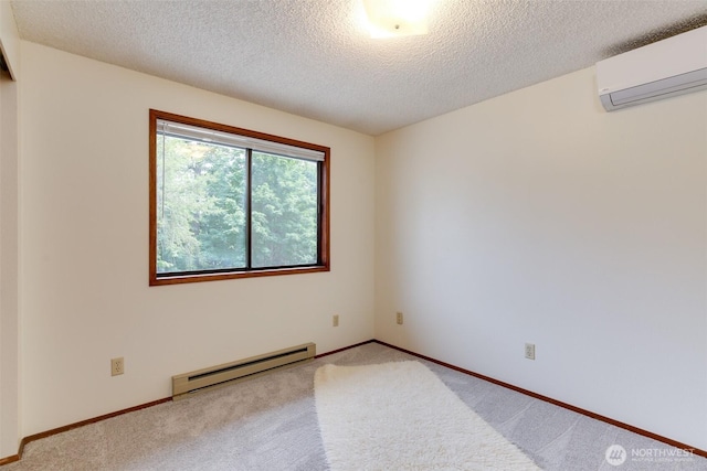 1264 SW Lanyard Loop Unit 2, Oak Harbor, WA 98277 - carpeted empty room featuring baseboard heating, a wall mounted AC, and a textured ceiling