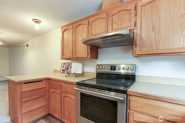1264 SW Lanyard Loop Unit 2, Oak Harbor, WA 98277 - kitchen featuring stainless steel electric stove, under cabinet range hood, a peninsula, light countertops, and a textured ceiling