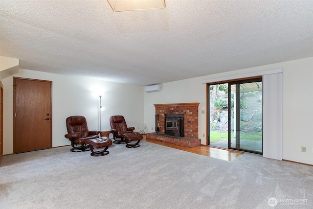1264 SW Lanyard Loop Unit 2, Oak Harbor, WA 98277 - sitting room featuring carpet floors, a wood stove, a wall unit AC, and a textured ceiling