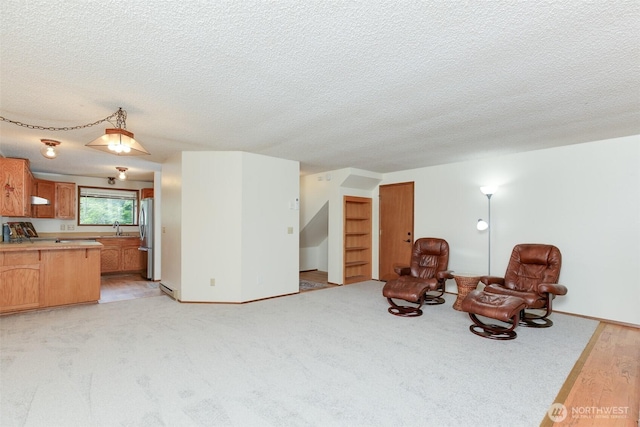 1264 SW Lanyard Loop Unit 2, Oak Harbor, WA 98277 - sitting room with a textured ceiling and light colored carpet