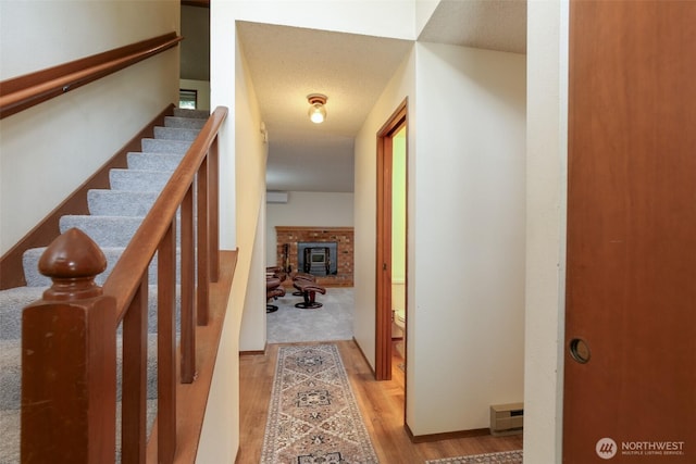 1264 SW Lanyard Loop Unit 2, Oak Harbor, WA 98277 - corridor with wood finished floors, stairs, and a wall mounted AC