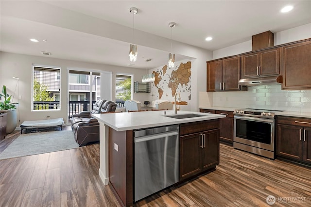 2015 79th St SE, Everett, WA 98203 - kitchen with appliances with stainless steel finishes, open floor plan, under cabinet range hood, dark wood-style flooring, and recessed lighting
