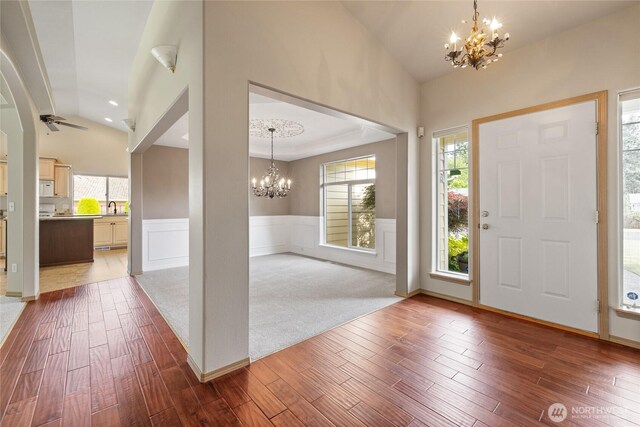 4703 235th St E, Spanaway, WA 98387 - foyer featuring a chandelier, lofted ceiling, healthy amount of natural light, hardwood / wood-style floors, and a wainscoted wall