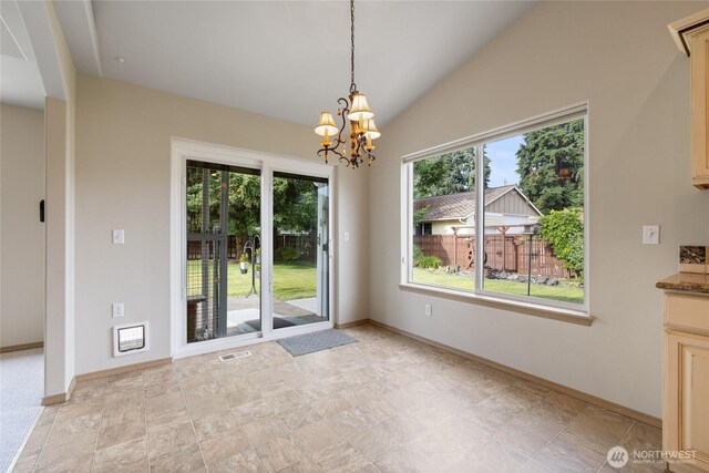 4703 235th St E, Spanaway, WA 98387 - unfurnished dining area with plenty of natural light, a chandelier, and vaulted ceiling