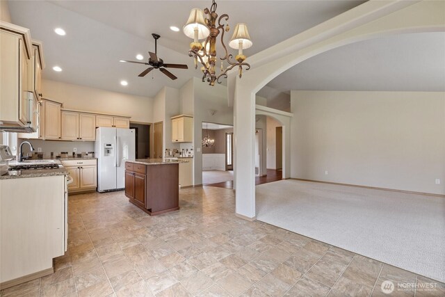 4703 235th St E, Spanaway, WA 98387 - kitchen featuring white fridge with ice dispenser, a ceiling fan, arched walkways, open floor plan, and recessed lighting