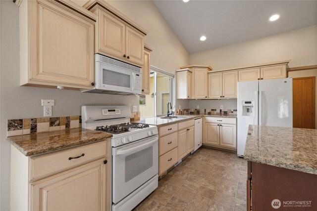4703 235th St E, Spanaway, WA 98387 - kitchen featuring white appliances, cream cabinetry, light stone countertops, and recessed lighting