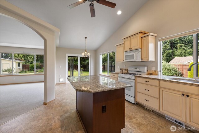 4703 235th St E, Spanaway, WA 98387 - kitchen featuring white appliances, ceiling fan, a center island, light stone countertops, and light brown cabinets