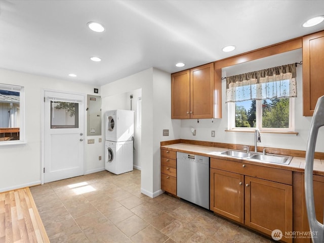 14324 Wayne Pl N, Seattle, WA 98133 - kitchen with dishwasher, stacked washer / dryer, brown cabinetry, light countertops, and recessed lighting