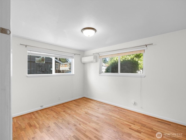 14324 Wayne Pl N, Seattle, WA 98133 - unfurnished room with a wall mounted AC and wood finished floors