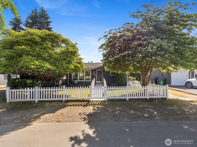 14324 Wayne Pl N, Seattle, WA 98133 - obstructed view of property with a fenced front yard and concrete driveway