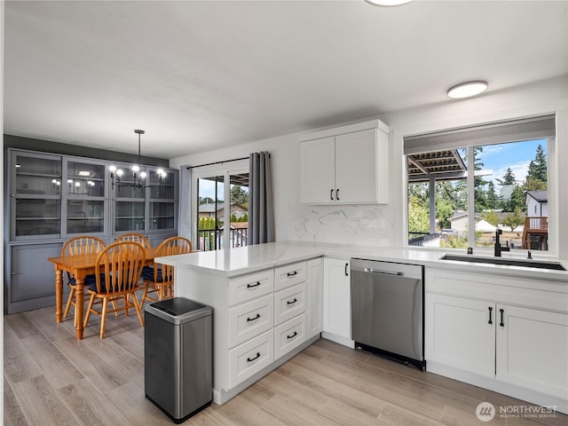 17301 6th Ave E, Spanaway, WA 98387 - kitchen with dishwasher, light countertops, a peninsula, white cabinetry, and a chandelier