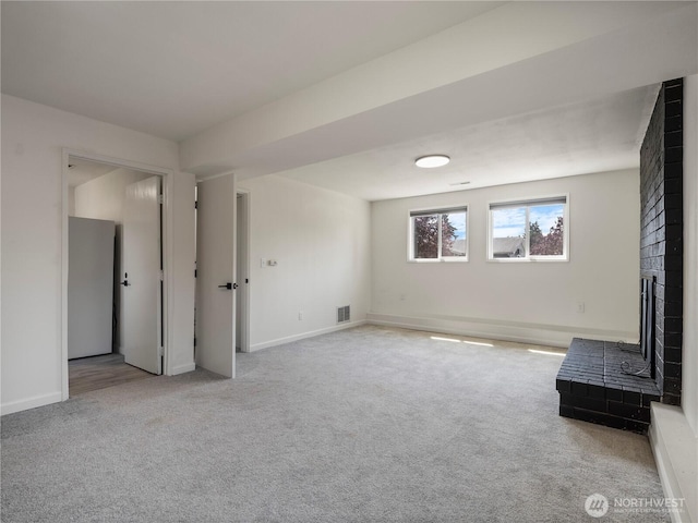 17301 6th Ave E, Spanaway, WA 98387 - unfurnished living room featuring carpet and a fireplace