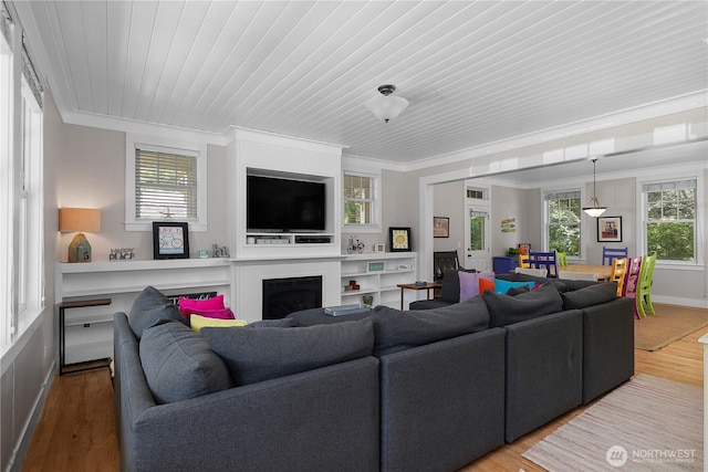 173 Meriweather St, Pacific Beach, WA 98571 - living room featuring a fireplace, ornamental molding, wood finished floors, and wooden ceiling