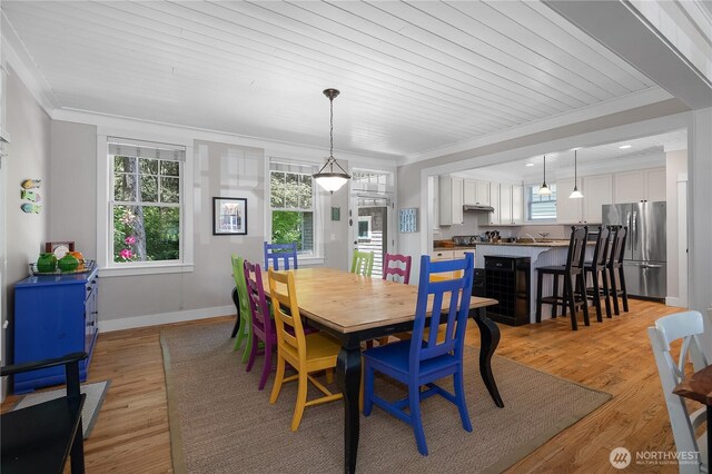 173 Meriweather St, Pacific Beach, WA 98571 - dining space featuring crown molding, healthy amount of natural light, and light wood-style flooring