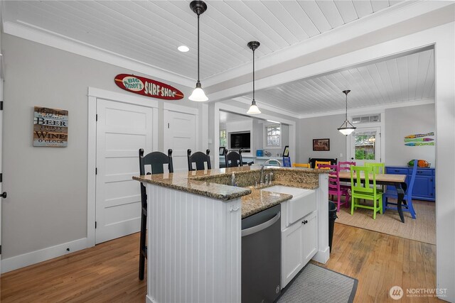 173 Meriweather St, Pacific Beach, WA 98571 - kitchen featuring dishwasher, light wood finished floors, white cabinets, ornamental molding, and decorative light fixtures