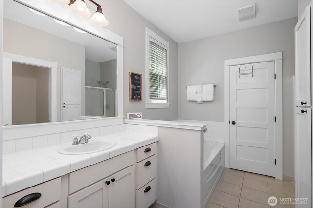 173 Meriweather St, Pacific Beach, WA 98571 - bathroom with vanity, tile patterned flooring, a bath, and a shower with shower door