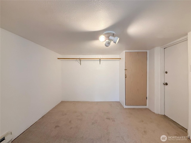 5302 Rockefeller Ave, Everett, WA 98203 - unfurnished bedroom featuring baseboard heating, light colored carpet, and a textured ceiling