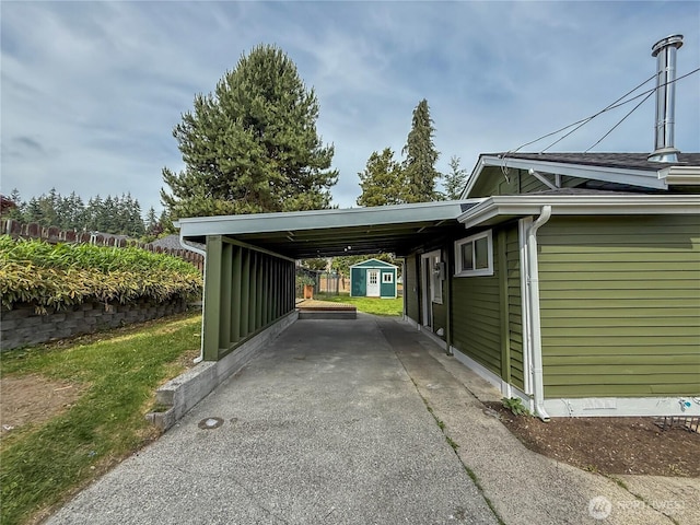 5302 Rockefeller Ave, Everett, WA 98203 - view of parking / parking lot with driveway, an attached carport, and a storage shed