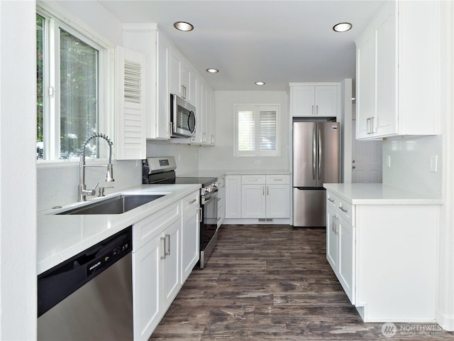 10105 6th Dr SE Unit B, Everett, WA 98208 - kitchen with stainless steel appliances, white cabinetry, dark wood-type flooring, light countertops, and recessed lighting